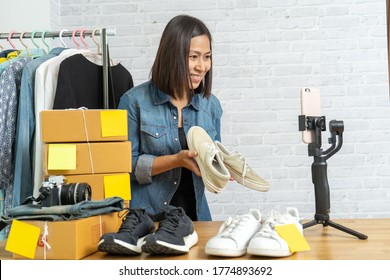 Asian Woman Using Smart Mobile Phone Taking Live Selling Online Shoes, Start Up Small Business Owner E-commerce Working At Home Office