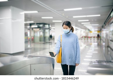 Asian Woman Using Smart Phone To Pay At Subway Station.