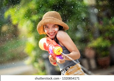 Asian woman are using water guns play in the Songkran festival