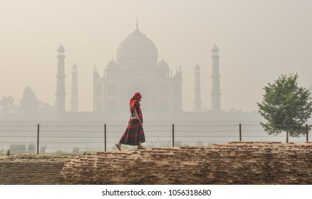 An Asian woman visit Taj Mahal at early morning in misty day. - Powered by Shutterstock