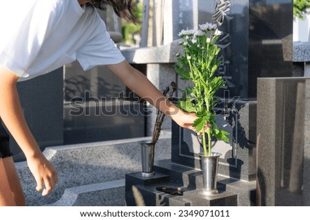 Asian woman visiting a grave