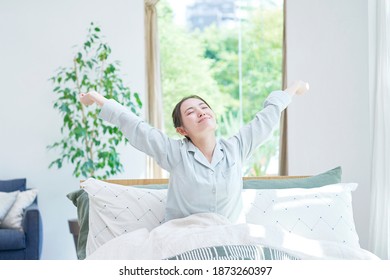 Asian Woman Waking Up In The Early Morning