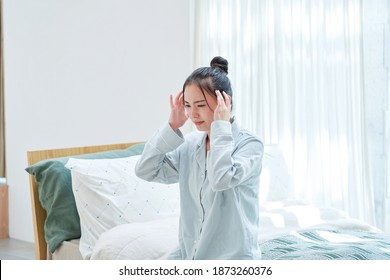 Asian Woman Waking Up With A Headache