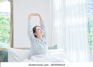 Asian Woman Waking Up At Home