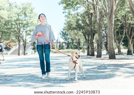 Asian woman walking the dog