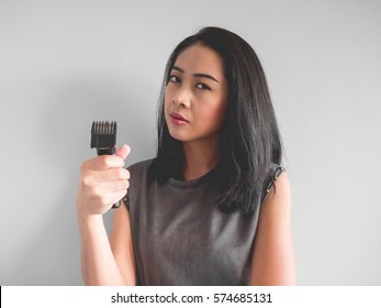 Asian Woman Wants To Cut Your Hair With Hair Clipper.