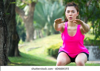 Asian Woman Warm Up To Exercise By Body Weight Squat In Park For Health