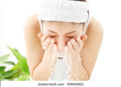 Asian Woman Washing A Face