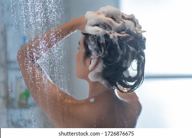 Asian woman washing hair and showering