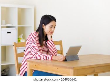 Asian Woman Watching Movie On Tablet