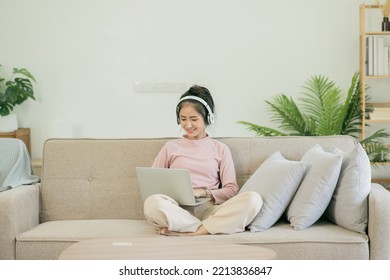 Asian Woman Watching Movies, Listening To Music, Video Calling At Home.