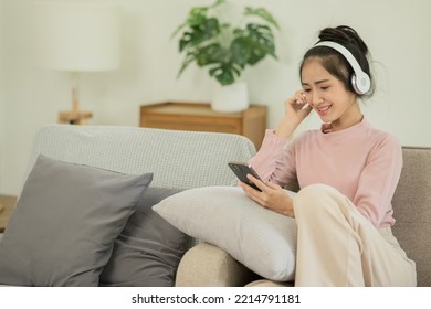 Asian Woman Watching Movies, Listening To Music, Video Calling At Home.