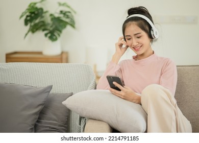 Asian Woman Watching Movies, Listening To Music, Video Calling At Home.