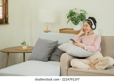 Asian Woman Watching Movies, Listening To Music, Video Calling At Home.