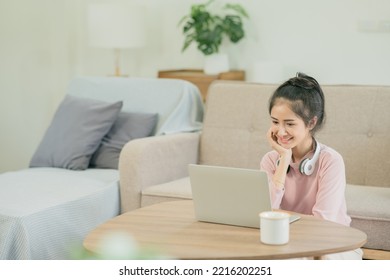 Asian Woman Watching Movies, Listening To Music, Video Calling At Home.