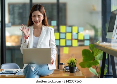 Asian Woman Watching Webinar On Laptop Computer Express Opinion Offer Solution At Virtual Meeting. Student Use Pc And Internet E-learning Remotely