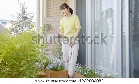 Asian woman watering the garden