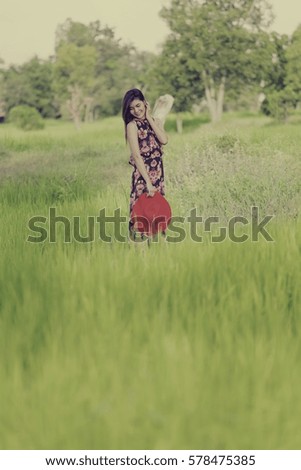 Asian woman wear dress  at rice field, Thailand.