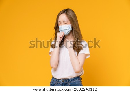 Asian woman wear masks to protect disease on yellow background.