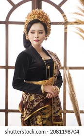 Asian woman wearing black Balinese Kebaya on large window background