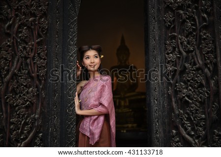 Asian woman wearing dress traditional thai costume in temple