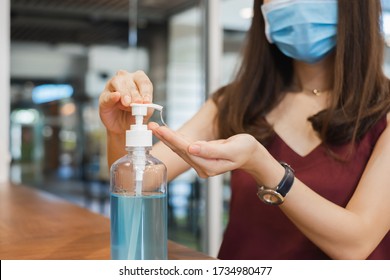 Asian woman wearing face mask wash hand by using sanitizer alcohol gel to prevent infection from coronavirus covid-19 - Powered by Shutterstock