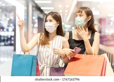 Asian Woman Wearing Face Mask. Happy Woman With Shopping Bags Enjoying In Shopping. Girl Holding Colour Paper Bag.Friends Walking In Shopping Mall.time Shopping Coronavirus Crisis Or Covid19 Outbreak