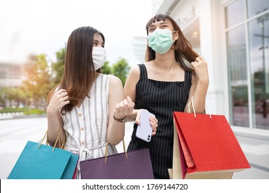 Asian Woman Wearing Face Mask. Happy Woman With Shopping Bags Enjoying In Shopping. Girl Holding Colour Paper Bag.Friends Walking In Shopping Mall.time Shopping Coronavirus Crisis Or Covid19 Outbreak