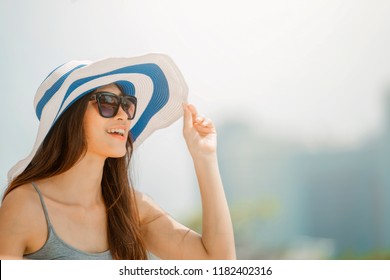 Asian Woman Wearing Fashion Straw Beach Hat For Skin Care Sun Protection. Face Skincare Beauty Concept. Beautiful Adult Girl Portrait On Summer Vacation Travel.