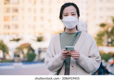 Asian Woman Wearing A Mask While Walking On The Street