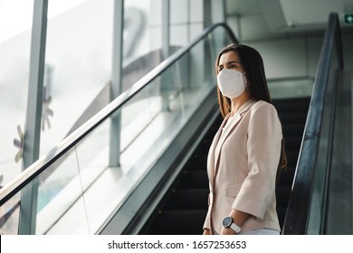 Asian Woman Wearing N95 Mask To Protect Pollution PM2.5 And Virus. COVID-19 Coronavirus And Air Pollution Pm2.5 Concept.