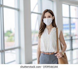 Asian Woman Is Wearing Surgical Mask Face Protection While She Is Commuting In The City