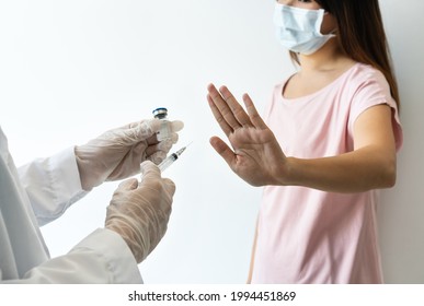 Asian Woman Wearing Surgical Mask Refuse Nurse Injection Or Vaccination. Rejection Of The Vaccine, Insecurity And Fear Concept.