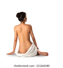 Asian Woman Wearing Towel Sitting On The Floor Back View, Isolated Over White