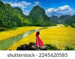 Asian woman wearing Vietnam culture traditional at Tam coc, Vietnam.