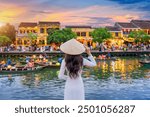 Asian woman wearing vietnam culture traditional at Hoi An ancient town,Hoi an city in Vietnam.