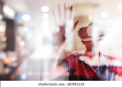 Asian Woman Wearing Virtual Reality Mask With Blur  Shopping Mall Picture In Background