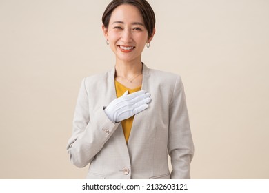 Asian woman wearing white gloves
