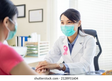 Asian Woman Wears Face Mask To Prevent COVID19 Has Breast Cancer Diagnosis In Hospital - Female Doctor Consulting To Patient In Patience And Putting Hand On Her