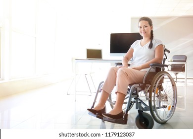 Asian Woman In Wheelchair In Office