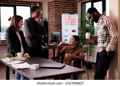 Asian woman wheelchair user with disability laughing with people in startup office, meeting on break. Female worker dealing with chronic health condition, talking to cheerful colleagues. - Powered by Shutterstock - Get 15% off with code: PIKWIZARD15