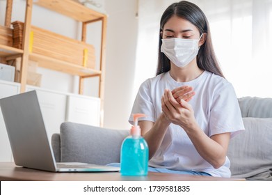 Asian Woman With White Face Mask Are Wash Her Hand, She Use Alcohol Gel, Sanitizer While Working In Her Home In Self Quarantine Policy. Work From Home, Covid 19, Germ Killer, New Normal Concept.