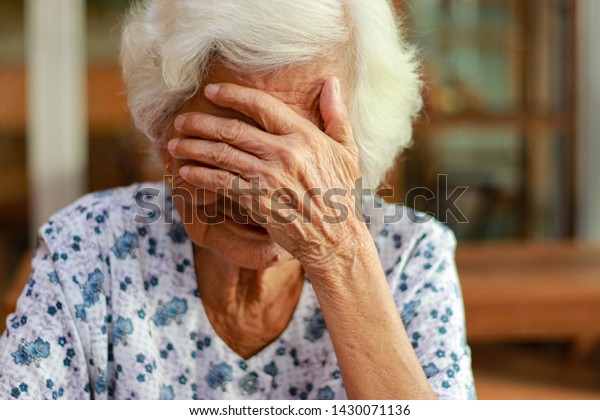 Asian woman with white hair\
shows signs of memory impairment. Health problems and treatment\
costs.
