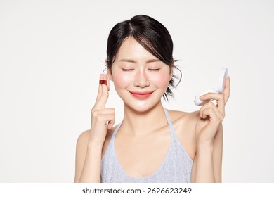 Asian woman who closes her eyes and applies cushion compacts