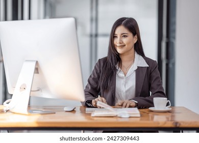 Asian woman working with Blank screen desktop computer in the office