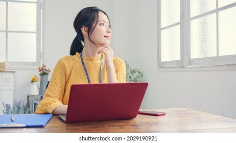 Asian Woman Working In The Casual Office.