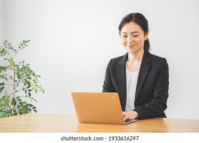 Asian Woman Working With A Computer