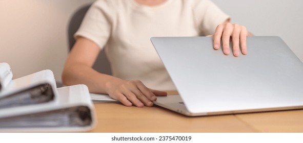 Asian woman working with computer laptop, female businesswoman open or Shutdown notebook with documents folder stack at home or office late night. Overworked, work hard and business concept