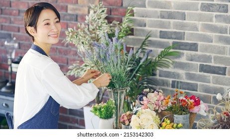 Asian Woman Working In Flower Shop. Flower Coordinator. Flower Arrangement.