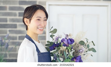 Asian Woman Working In Flower Shop. Flower Coordinator. Flower Arrangement.